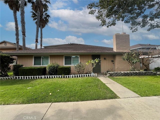 2562 N Bourbon St, Orange, CA 92865 - single story home featuring a chimney, a front lawn, and board and batten siding