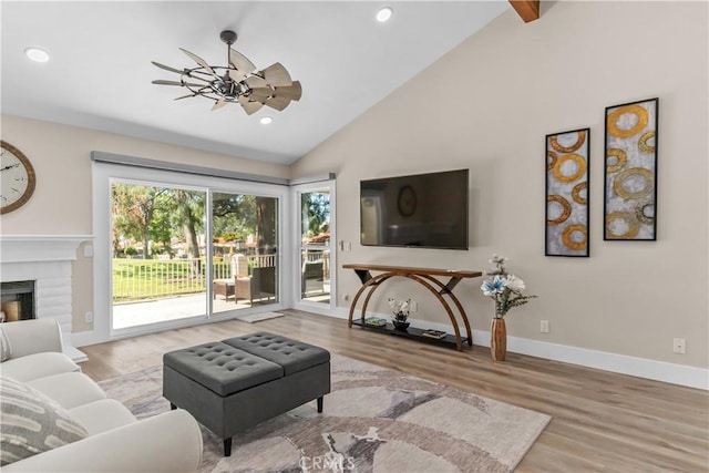 living room with wood finished floors, a ceiling fan, recessed lighting, baseboards, and a brick fireplace