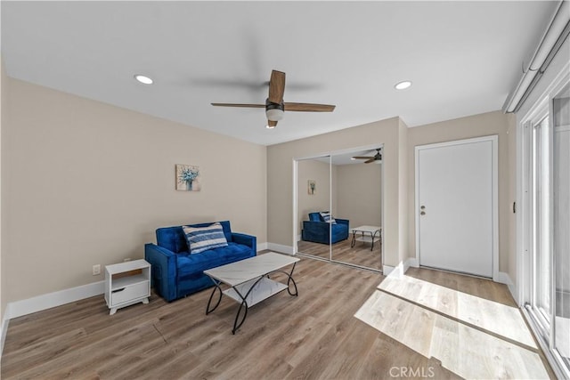sitting room with ceiling fan, light wood finished floors, baseboards, and recessed lighting