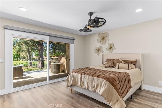 bedroom featuring access to exterior, wood finished floors, baseboards, and recessed lighting