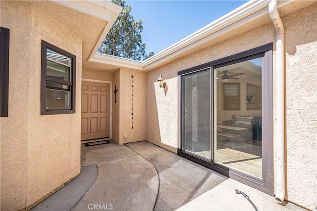entrance to property featuring stucco siding