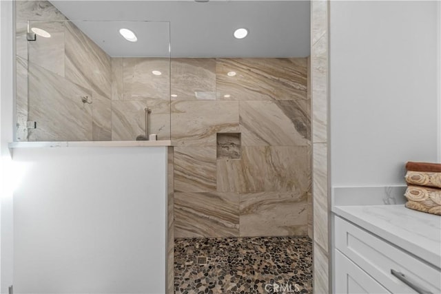 bathroom featuring walk in shower and recessed lighting