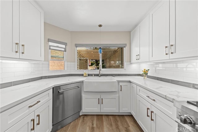 kitchen with dishwasher, a sink, white cabinetry, and tasteful backsplash