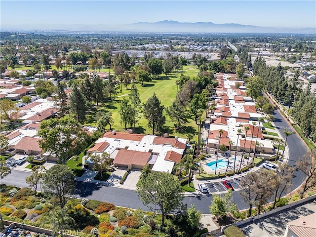 view of property location with a mountainous background, nearby suburban area, and a golf course