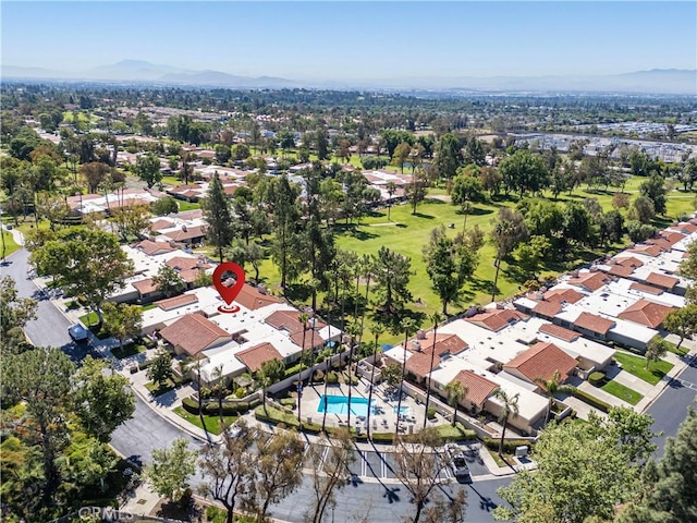 view of property location featuring nearby suburban area, a mountainous background, and a pool