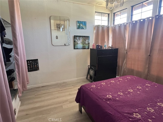 bedroom featuring wood finished floors and baseboards