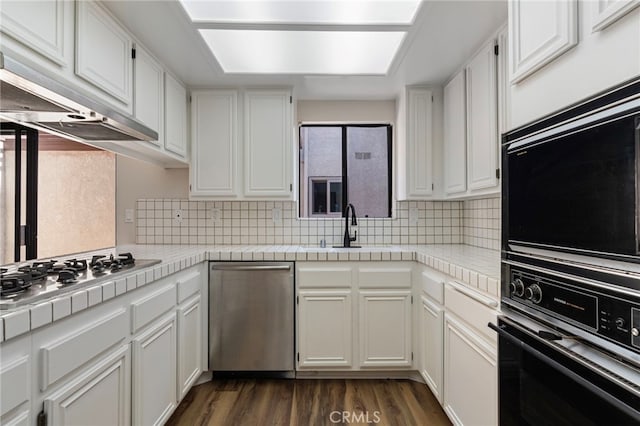 676 Shepard St Unit 6, San Pedro, CA 90731 - kitchen featuring stainless steel appliances, a sink, under cabinet range hood, white cabinets, and dark wood-style floors
