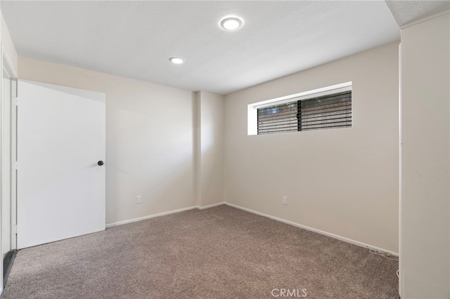 unfurnished room with carpet, recessed lighting, and baseboards