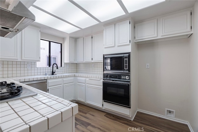 676 Shepard St Unit 6, San Pedro, CA 90731 - kitchen featuring appliances with stainless steel finishes, tile countertops, island exhaust hood, wood finished floors, and decorative backsplash