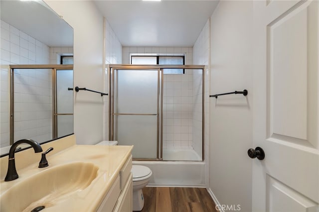 676 Shepard St Unit 6, San Pedro, CA 90731 - bathroom featuring wood finished floors, toilet, vanity, and bath / shower combo with glass door