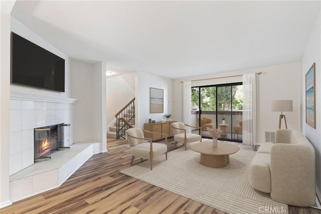 676 Shepard St Unit 6, San Pedro, CA 90731 - living room with stairway, wood finished floors, and a tile fireplace
