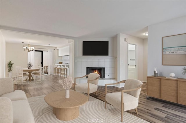 676 Shepard St Unit 6, San Pedro, CA 90731 - living room featuring wood finished floors, a tile fireplace, and a chandelier