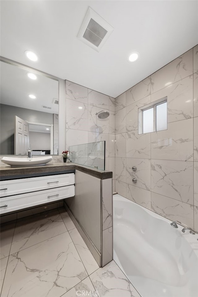 5653 Franklin Ave, Los Angeles, CA 90028 - full bath with vanity, tub / shower combination, recessed lighting, and marble finish floors