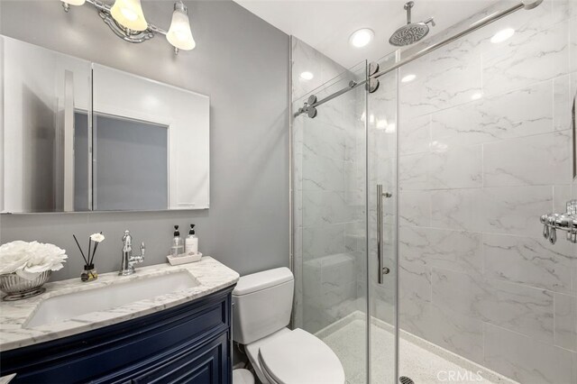 5653 Franklin Ave, Los Angeles, CA 90028 - full bathroom featuring a marble finish shower, vanity, and toilet