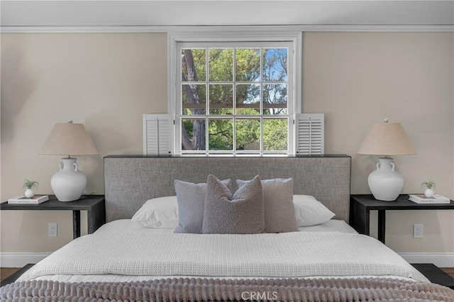 bedroom featuring baseboards and wood finished floors