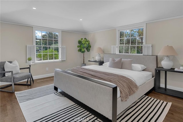 bedroom featuring baseboards, multiple windows, wood finished floors, recessed lighting, and ornamental molding