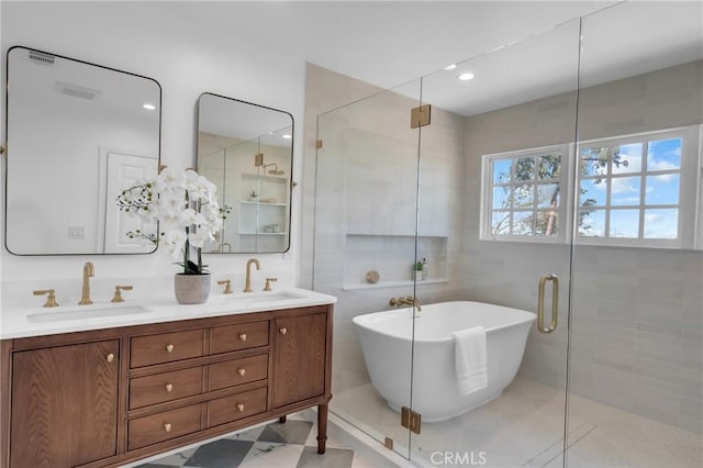 full bathroom featuring a stall shower, a freestanding bath, and double vanity