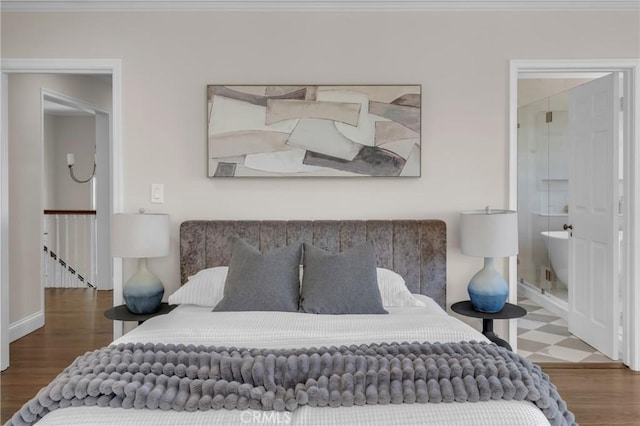 bedroom featuring wood finished floors, baseboards, and ornamental molding