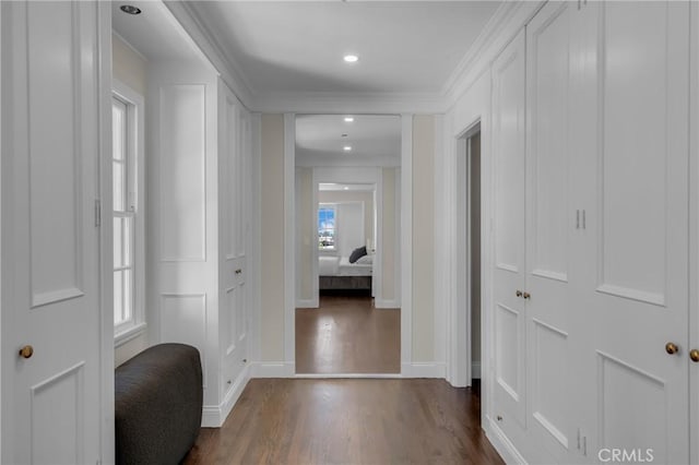hallway featuring dark wood-style floors, baseboards, crown molding, and recessed lighting