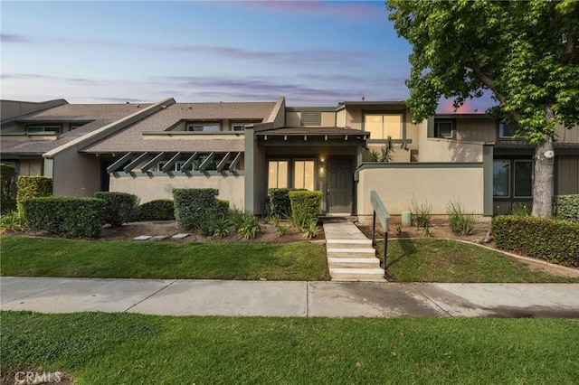 1326 Via Del Rio, Corona, CA 92882 - view of front of property featuring stucco siding, a front lawn, and a shingled roof