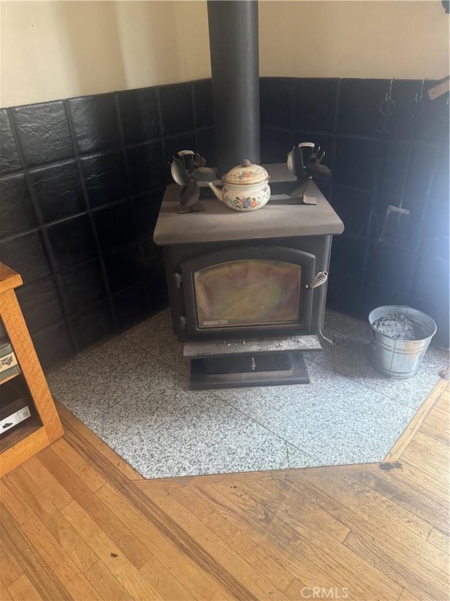 5625 Headwaters Rd, Forest Ranch, CA 95942 - detailed view of a wood stove, wood finished floors, wainscoting, and tile walls