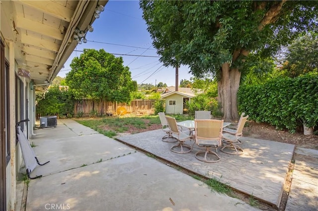 16060 Villa Flores Dr, Hacienda Heights, CA 91745 - view of patio / terrace with cooling unit, a fenced backyard, an outbuilding, outdoor dining space, and a storage shed