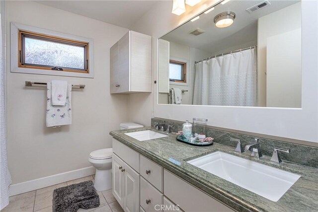14048 Wagon Mound Rd, Rancho Cascades, CA 91342 - bathroom with toilet, double vanity, tile patterned flooring, baseboards, and curtained shower