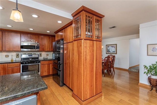 14048 Wagon Mound Rd, Rancho Cascades, CA 91342 - kitchen with stainless steel appliances, light wood-style flooring, baseboards, glass insert cabinets, and backsplash