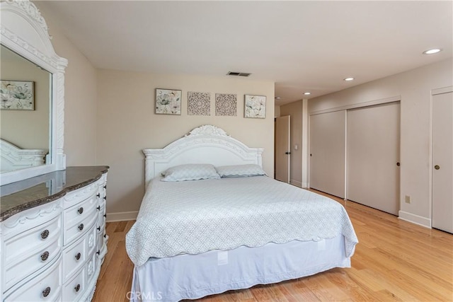 14048 Wagon Mound Rd, Rancho Cascades, CA 91342 - bedroom featuring light wood-type flooring, recessed lighting, baseboards, and multiple closets