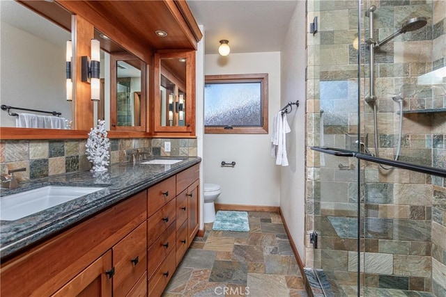 14048 Wagon Mound Rd, Rancho Cascades, CA 91342 - bathroom with double vanity, stone tile flooring, a stall shower, and decorative backsplash