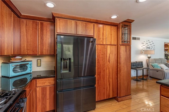 14048 Wagon Mound Rd, Rancho Cascades, CA 91342 - kitchen with refrigerator with ice dispenser, brown cabinetry, recessed lighting, open floor plan, and ornamental molding