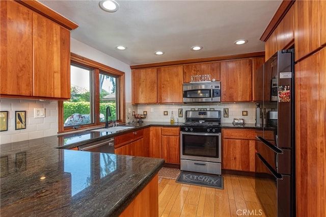 14048 Wagon Mound Rd, Rancho Cascades, CA 91342 - kitchen featuring stainless steel appliances, a sink, brown cabinetry, recessed lighting, and tasteful backsplash