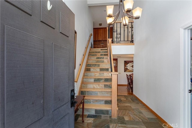 14048 Wagon Mound Rd, Rancho Cascades, CA 91342 - staircase featuring stone finish floors, a chandelier, and baseboards