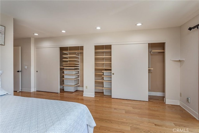 14048 Wagon Mound Rd, Rancho Cascades, CA 91342 - bedroom featuring multiple closets, wood finished floors, recessed lighting, and baseboards