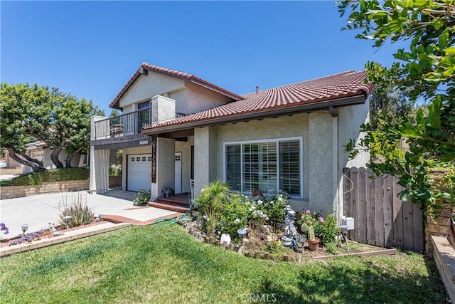 14048 Wagon Mound Rd, Rancho Cascades, CA 91342 - mediterranean / spanish-style home featuring concrete driveway, stucco siding, a balcony, an attached garage, and a tiled roof