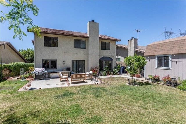 14048 Wagon Mound Rd, Rancho Cascades, CA 91342 - rear view of property featuring a chimney, a patio, a tile roof, and a lawn