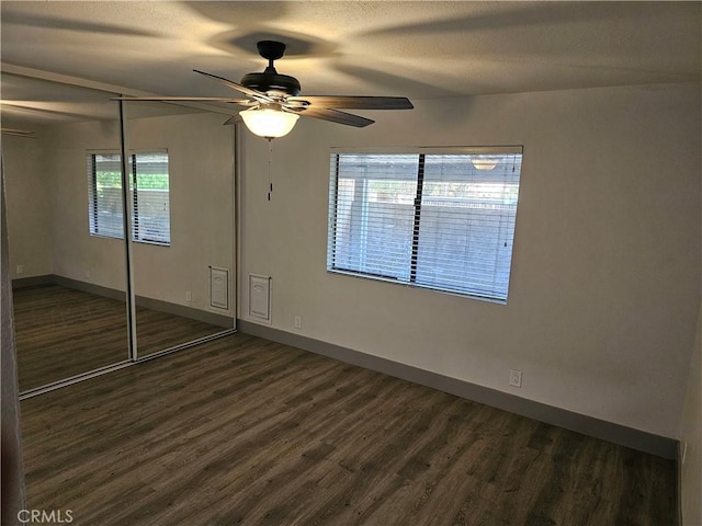 12860 Perris Blvd Unit D6, Moreno Valley, CA 92553 - unfurnished bedroom featuring wood finished floors, baseboards, a closet, and a ceiling fan