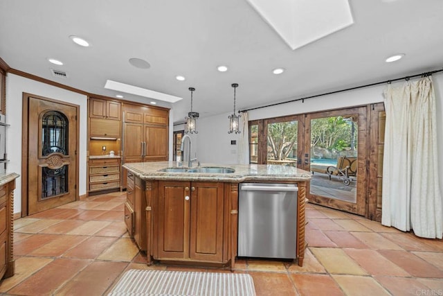 kitchen featuring stainless steel appliances, a sink, brown cabinets, recessed lighting, and a skylight