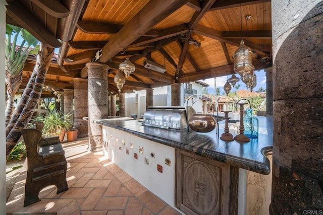 view of patio with exterior kitchen, grilling area, and a gazebo