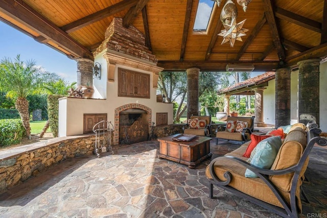 view of patio / terrace featuring a gazebo and an outdoor living space with a fireplace