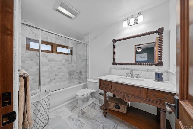 full bath featuring toilet, vanity, bath / shower combo with glass door, and marble finish flooring
