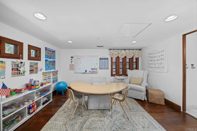 dining area featuring dark wood-style flooring and recessed lighting