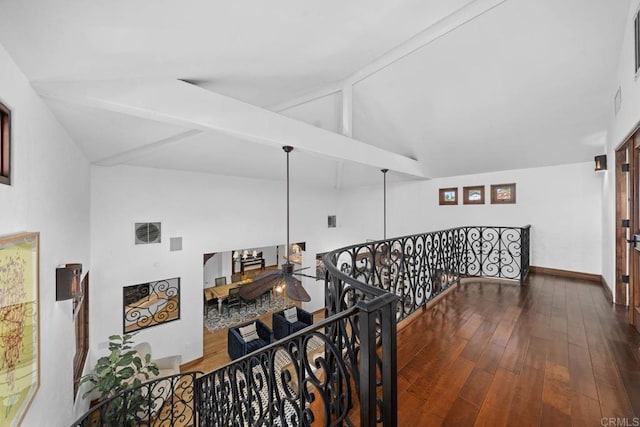 hallway with beam ceiling, high vaulted ceiling, wood finished floors, an upstairs landing, and baseboards
