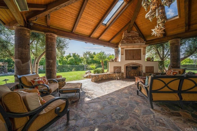 view of patio / terrace featuring a gazebo and an outdoor living space with a fireplace