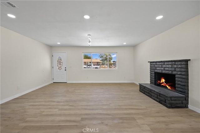 40635 159th St E, Lancaster, CA 93535 - unfurnished living room featuring a fireplace, light wood-style flooring, recessed lighting, and baseboards