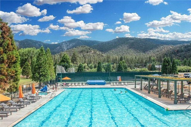 1517 Woodland Dr, Pine Mountain Club, CA 93222 - community pool with a mountain view, a view of trees, fence, and a patio