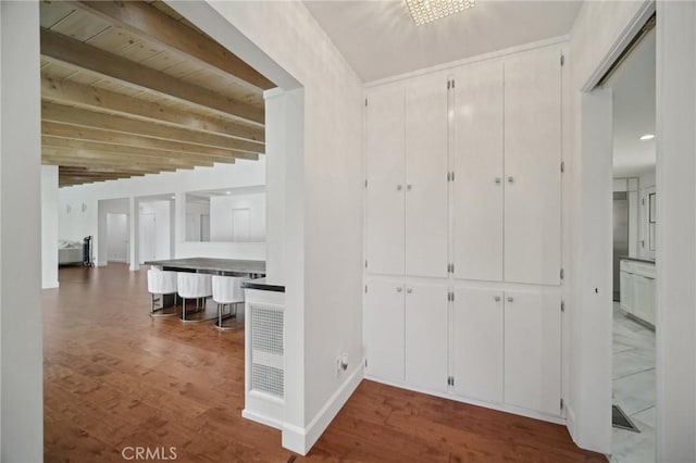 12218 Sarazen Pl, Granada Hills, CA 91344 - corridor with baseboards, wood finished floors, and beamed ceiling
