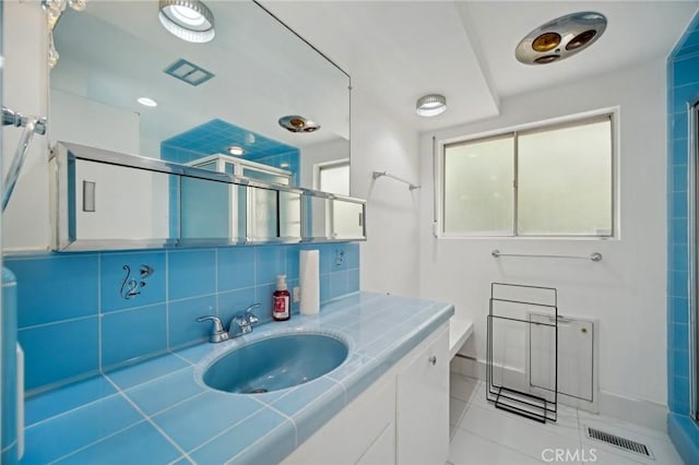 12218 Sarazen Pl, Granada Hills, CA 91344 - full bath featuring a shower stall, tile patterned flooring, baseboards, vanity, and decorative backsplash
