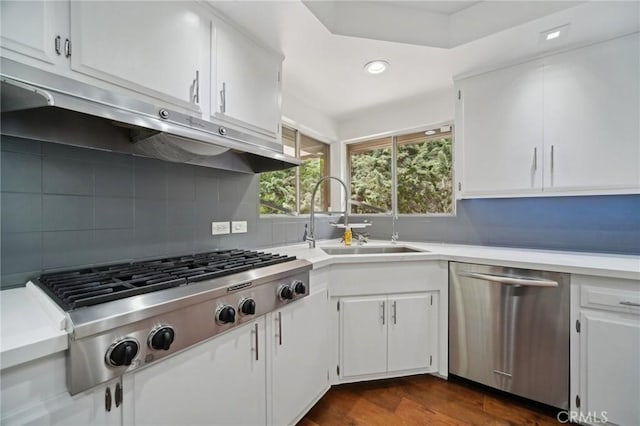 12218 Sarazen Pl, Granada Hills, CA 91344 - kitchen featuring appliances with stainless steel finishes, a sink, light countertops, decorative backsplash, and white cabinets