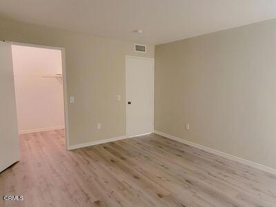 spare room with light wood finished floors and baseboards